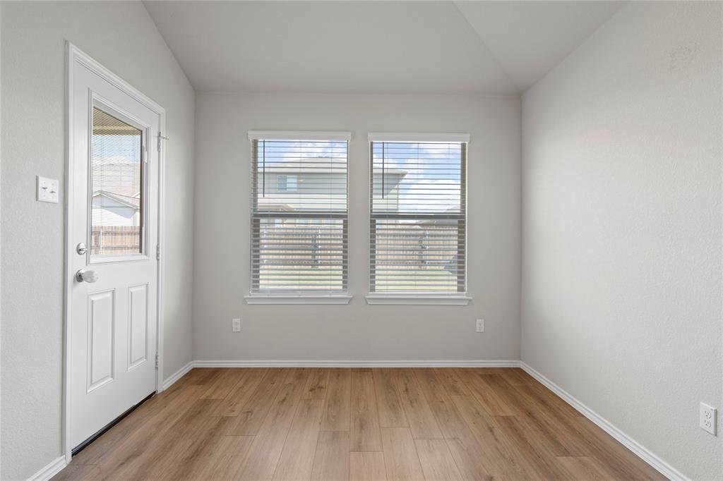 3012 Sherco Road Lorena, TX 76655 - Photo 6 of 14 an empty room with wooden floor and windows