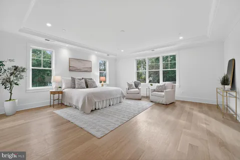 a bedroom with furniture and a large window