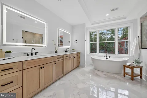 a large bathroom with a large tub and sink