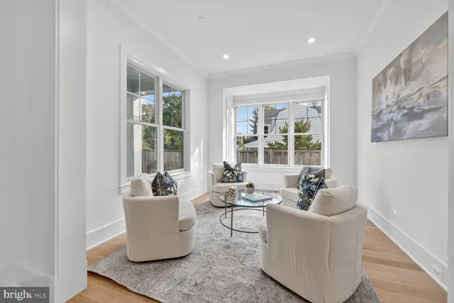 a living room with furniture and large windows