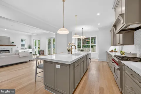 a kitchen with stainless steel appliances granite countertop a stove and a wooden floors
