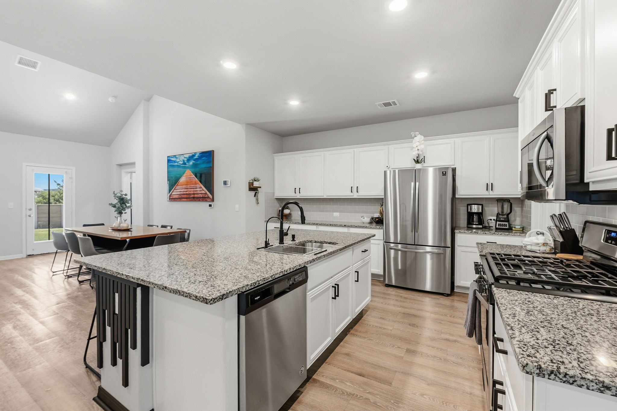 142 Brunnen Way Georgetown, TX 78626 - Photo 4 of 22 Culinary dreams come to life in this open kitchen, featuring an island with ample counter space and state-of-the-art appliances.
