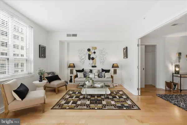 a living room with furniture rug and window
