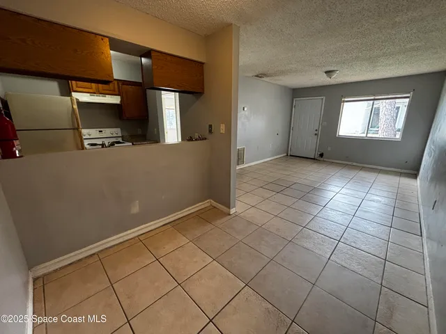 a kitchen with a sink a refrigerator and washer
