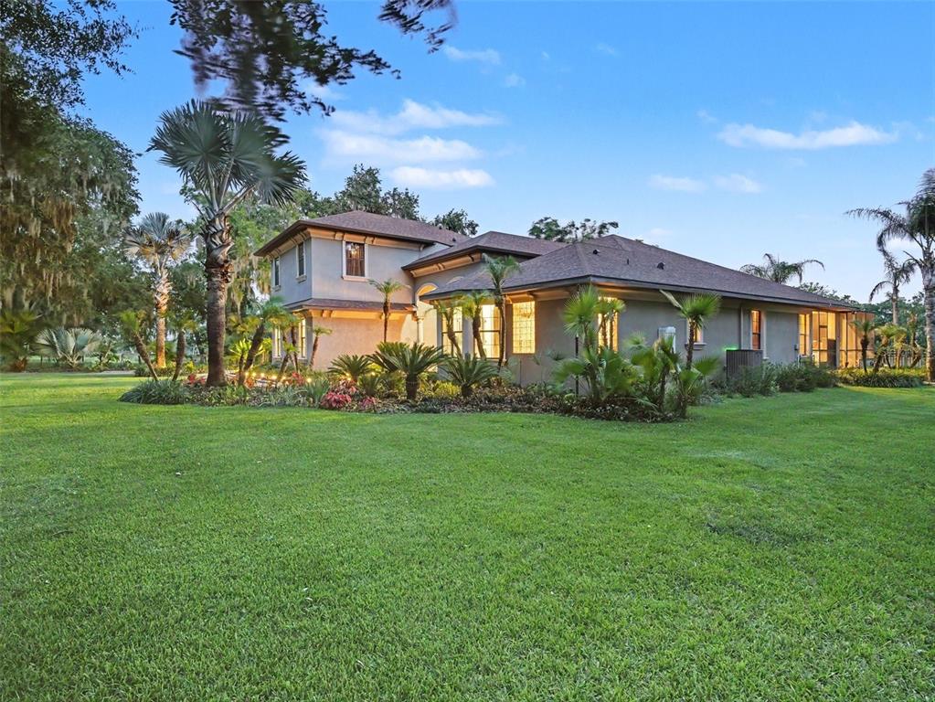 339 Corbett Road Lithia, FL 33547 - Photo 2 of 38 a front view of a house with a garden