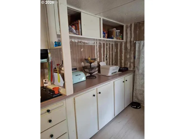 a white refrigerator freezer and a dishwasher sitting inside of a cabinet