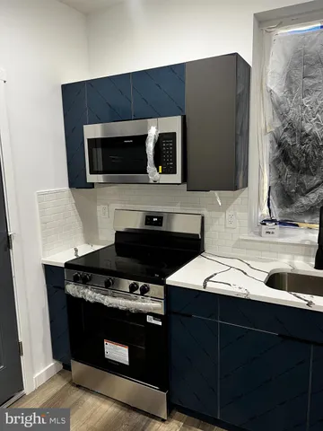 a kitchen with a sink and a stove top oven