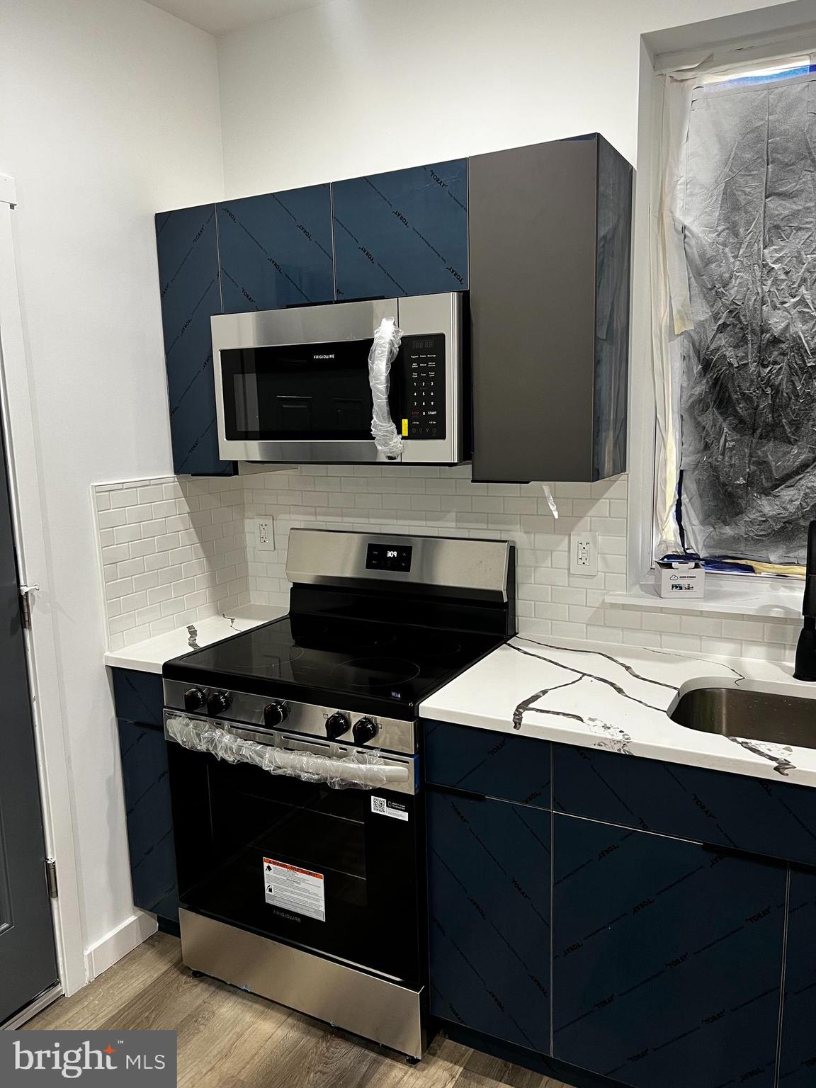1551 Church Street, Unit 1 Philadelphia, PA 19124 - Photo 2 of 8 a kitchen with a sink and a stove top oven