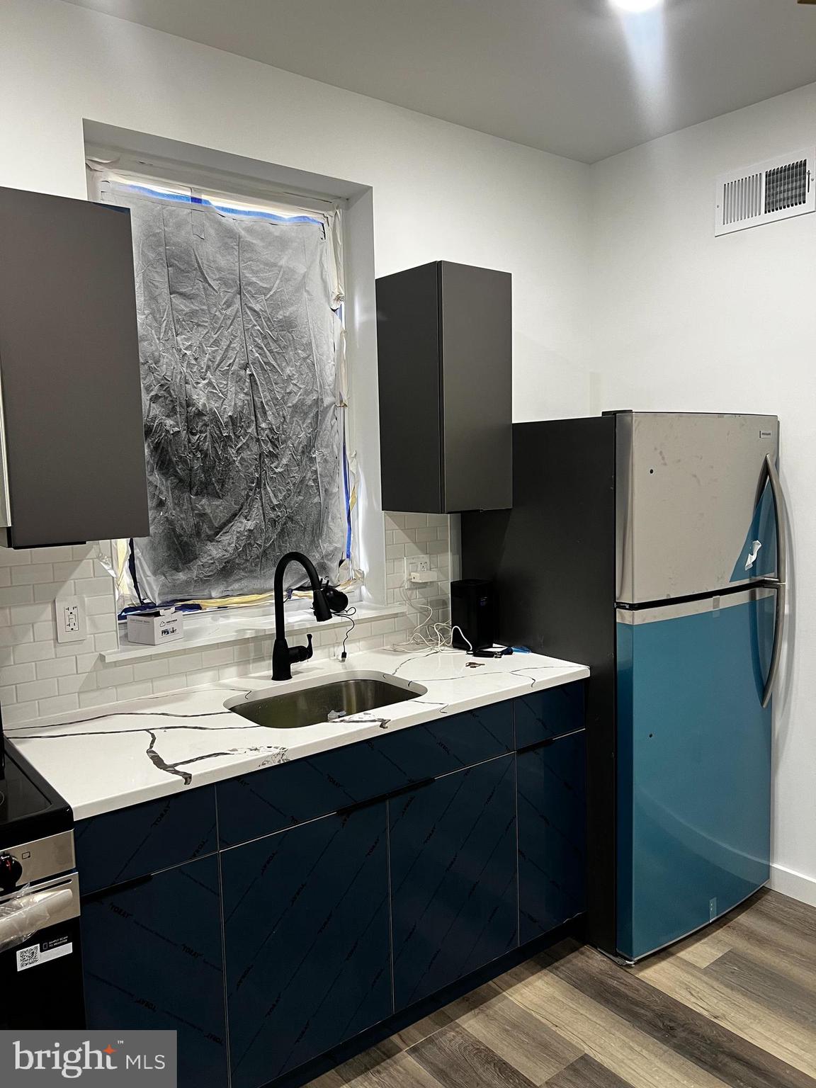 1551 Church Street, Unit 1 Philadelphia, PA 19124 - Photo 3 of 8 a bathroom with a double vanity sink and mirror