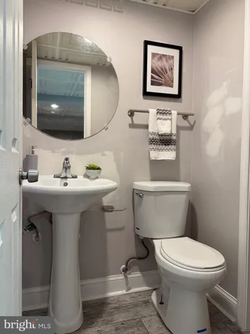 a bathroom with a toilet sink and mirror