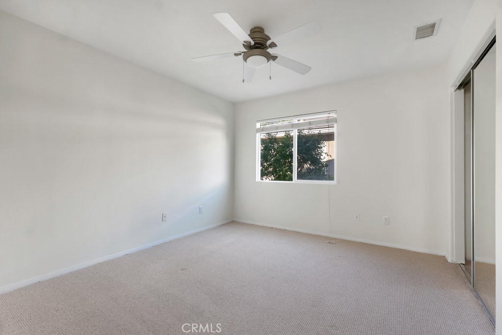 11205 Salerno Porter Ranch Porter Ranch, CA 91326 - Photo 25 of 43 an empty room with a chandelier fan and windows