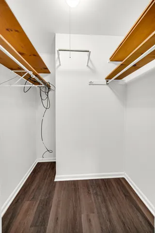 a view of a room with wooden floor and white walls