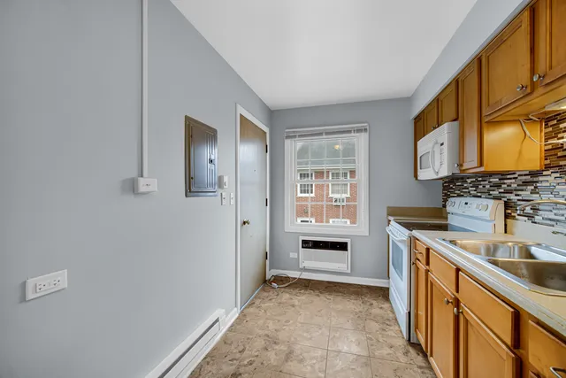 a bathroom with a sink a stove and a mirror