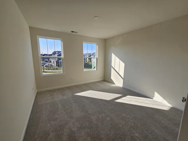 a view of an empty room with windows