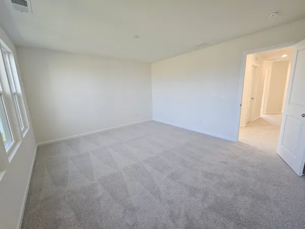 a view of an empty room and a window