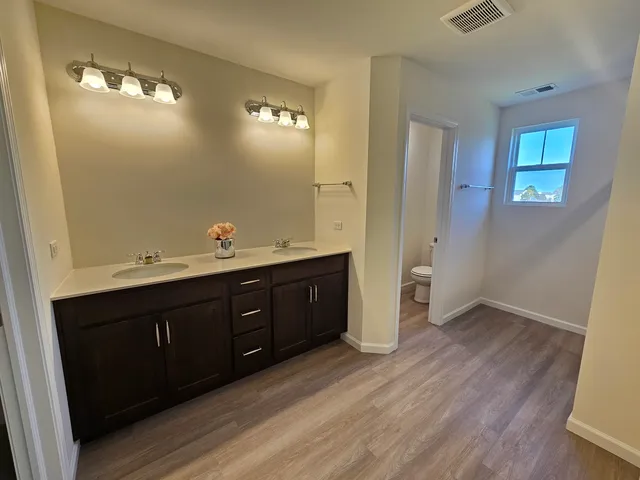 a bathroom with a double vanity sink and mirror