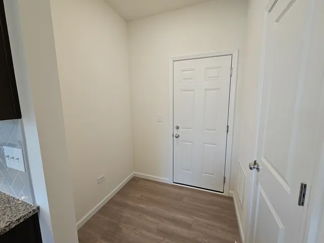 an empty room with wooden floor