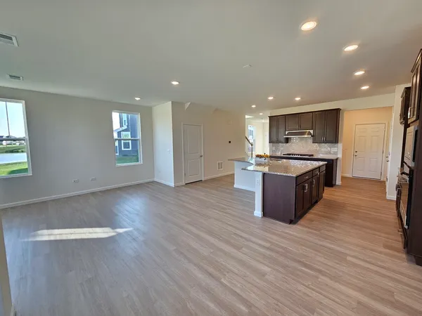 a large kitchen with stainless steel appliances granite countertop a large counter top and a stove