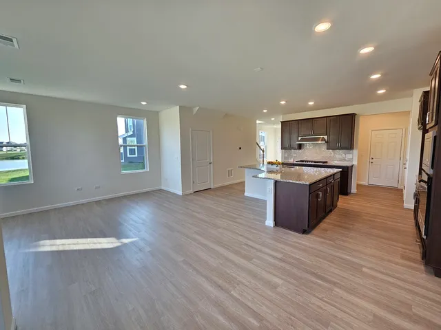 a large kitchen with stainless steel appliances granite countertop a large counter top and a stove