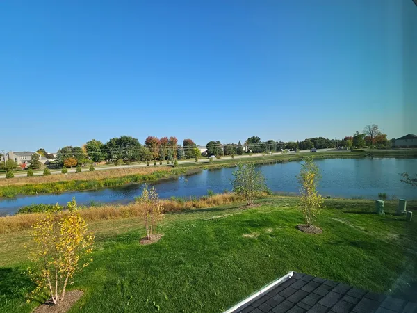 a view of a lake with houses in the back