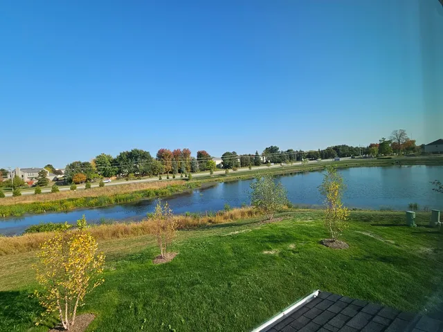 a view of a lake with houses in the back