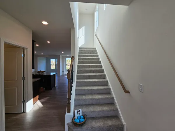 a view of entryway and hall with wooden floor