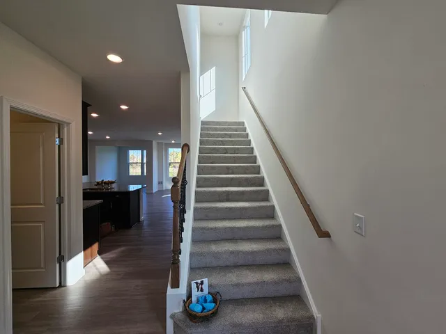 a view of entryway and hall with wooden floor