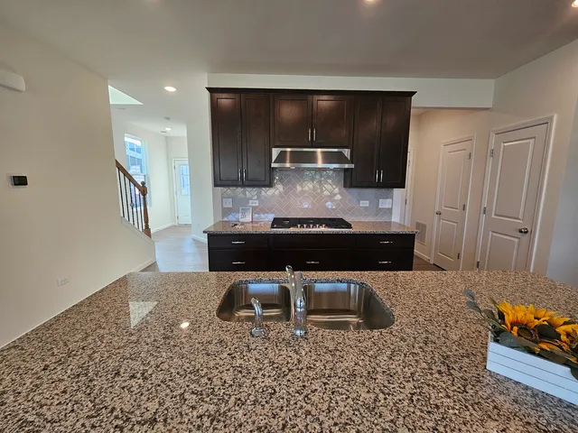 a kitchen with a sink and cabinets