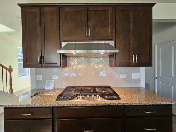 a stove top oven sitting inside of a kitchen