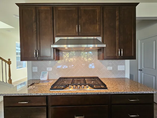 a stove top oven sitting inside of a kitchen