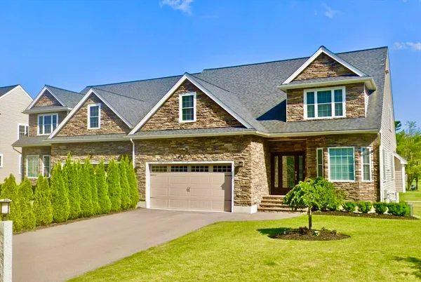 a front view of a house with a yard and garage