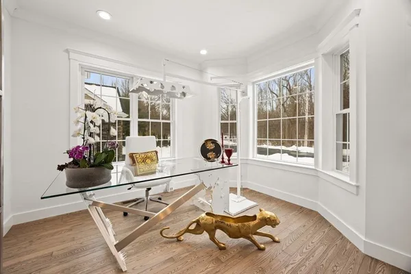 a living room with furniture a flat screen tv and a window