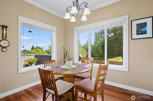 an aerial view of a house with a yard and a large tree