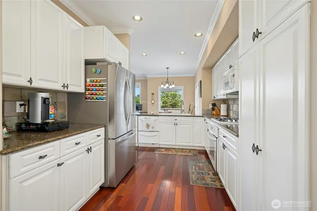 a view of a chair and table in backyard of the house
