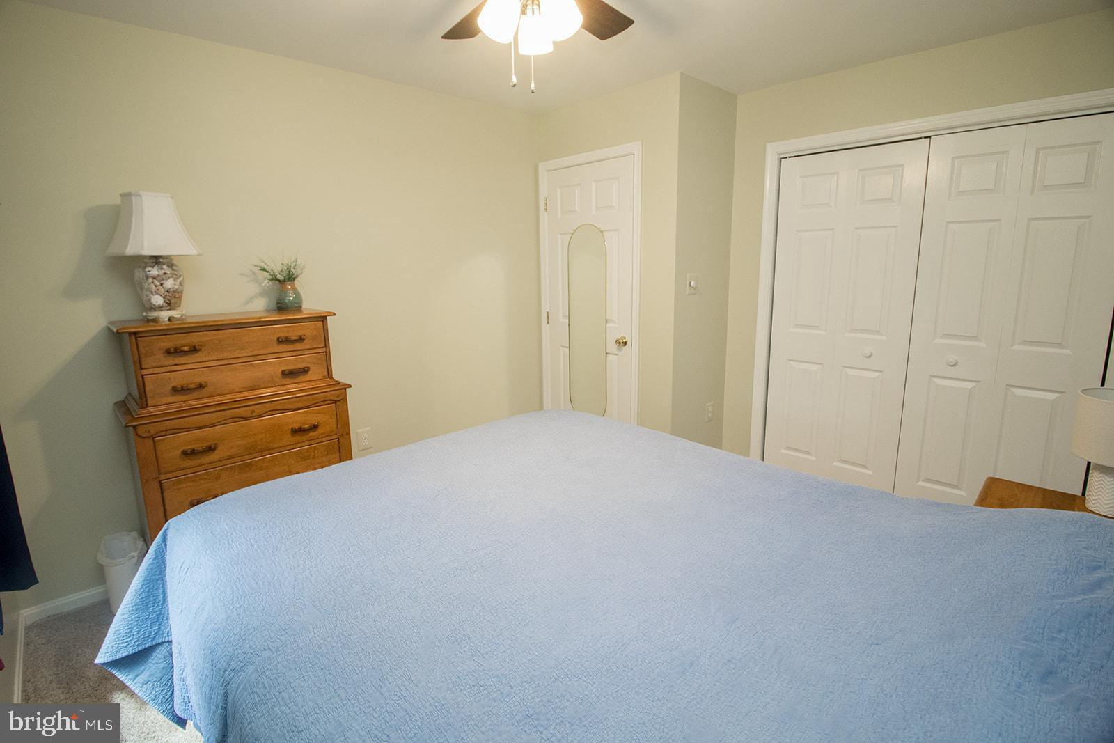 11620 Big Sandy Run Road Lusby, MD 20657 - Photo 15 of 64 a bedroom with a bed and a chandelier