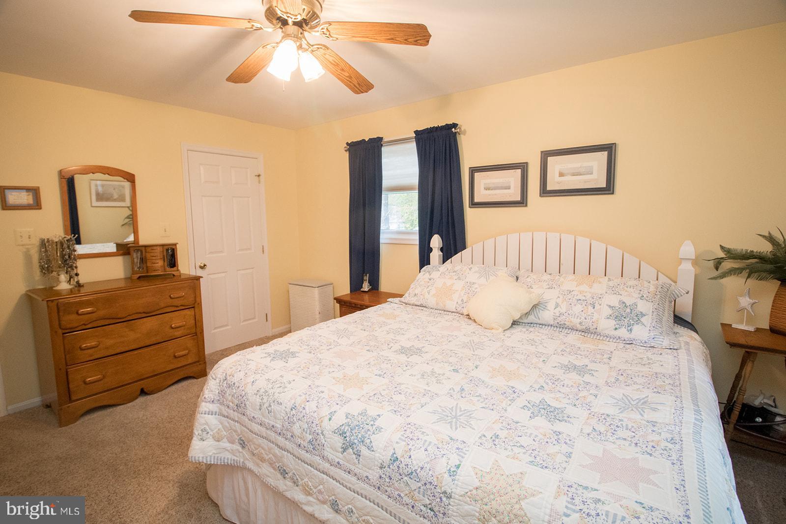 11620 Big Sandy Run Road Lusby, MD 20657 - Photo 17 of 64 a bedroom with a bed and a dresser