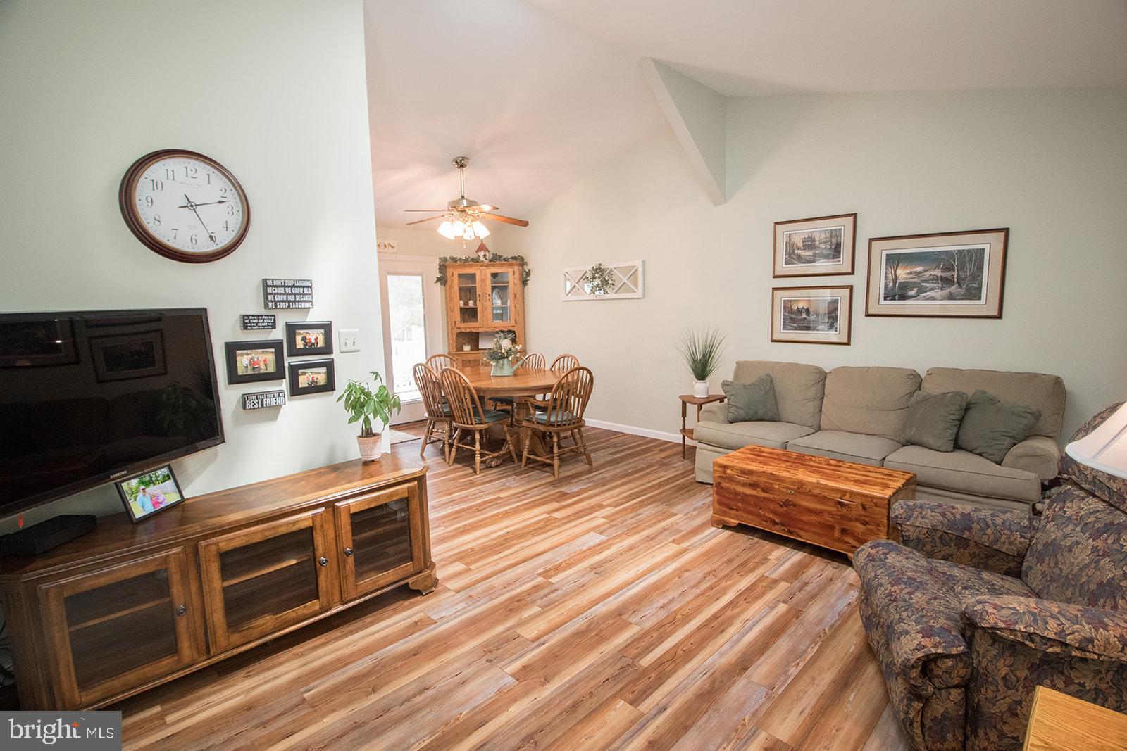 11620 Big Sandy Run Road Lusby, MD 20657 - Photo 24 of 64 a living room with furniture a flat screen tv and a fireplace