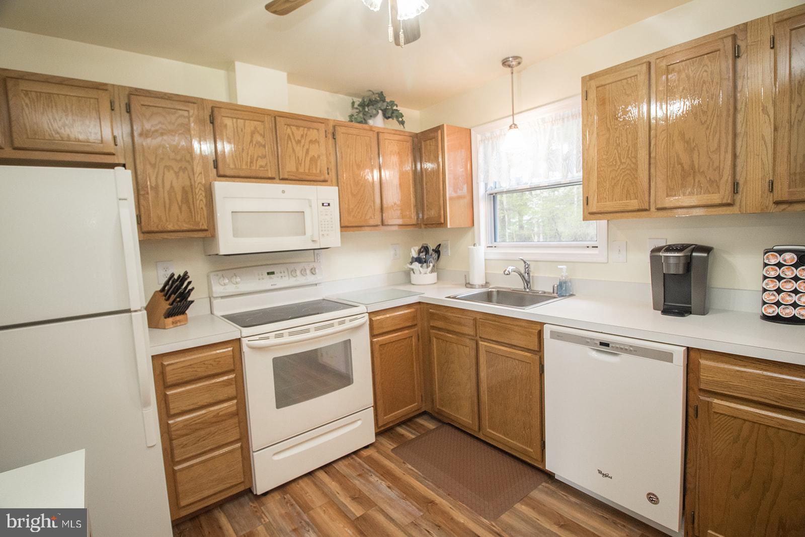 11620 Big Sandy Run Road Lusby, MD 20657 - Photo 34 of 64 a kitchen with a white cabinets and white appliances