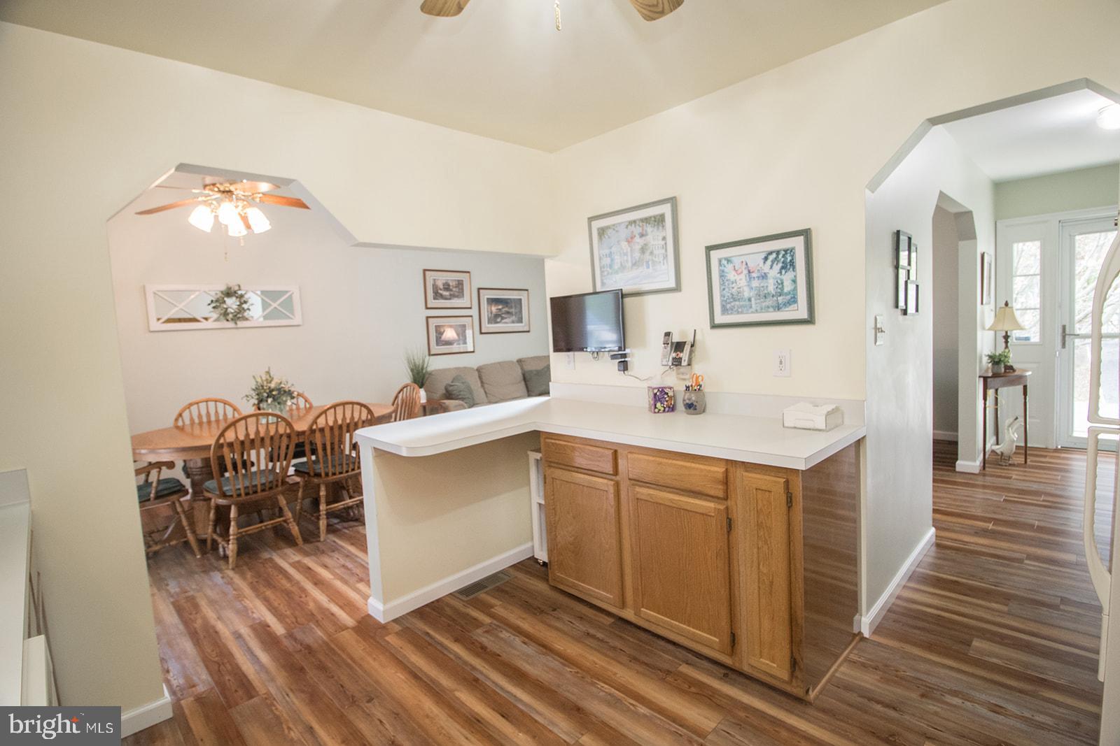 11620 Big Sandy Run Road Lusby, MD 20657 - Photo 36 of 64 a kitchen with a sink cabinets and dining table chair
