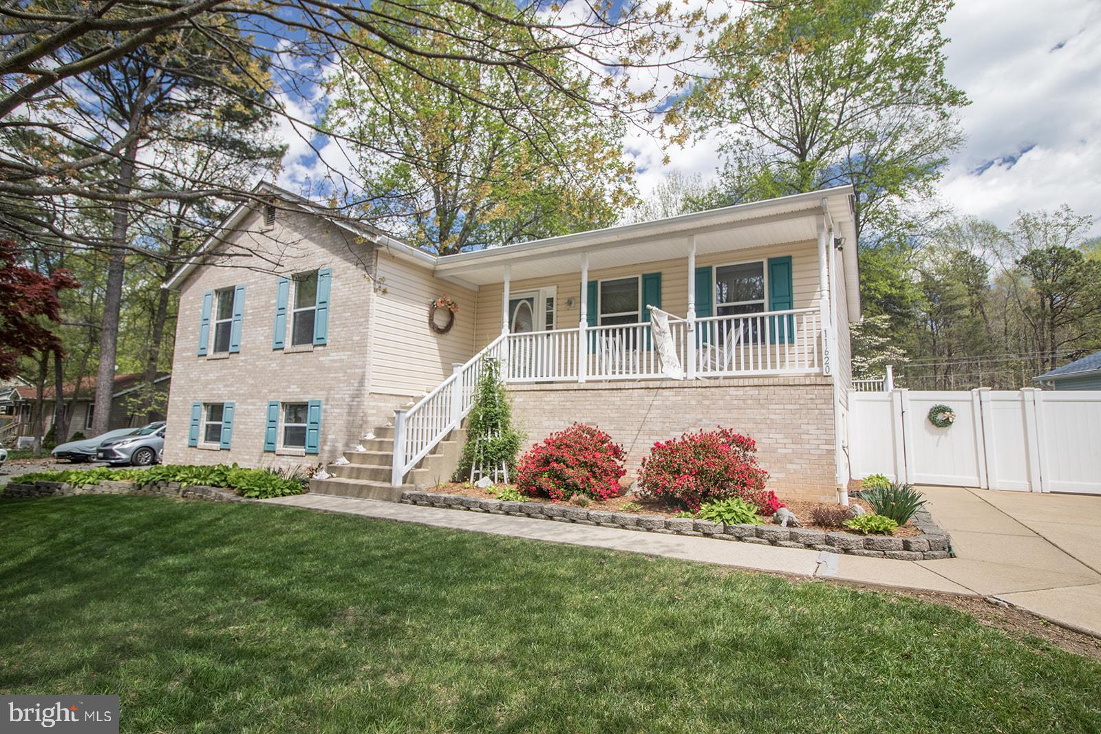 11620 Big Sandy Run Road Lusby, MD 20657 - Photo 4 of 64 front view of a house with a yard