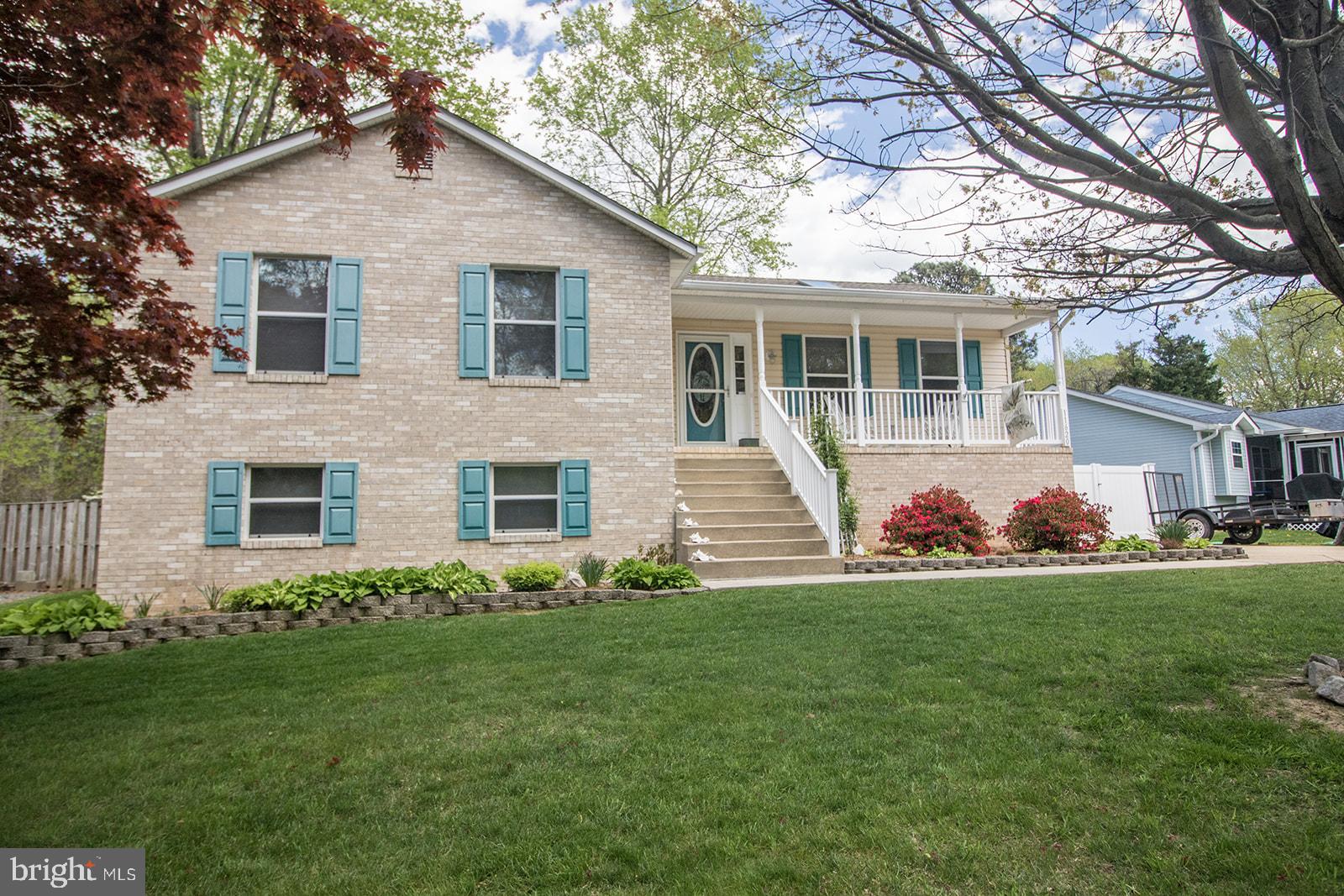 11620 Big Sandy Run Road Lusby, MD 20657 - Photo 6 of 64 a front view of a house with a garden