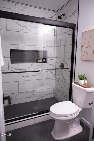 a bathroom with a toilet a sink and shower