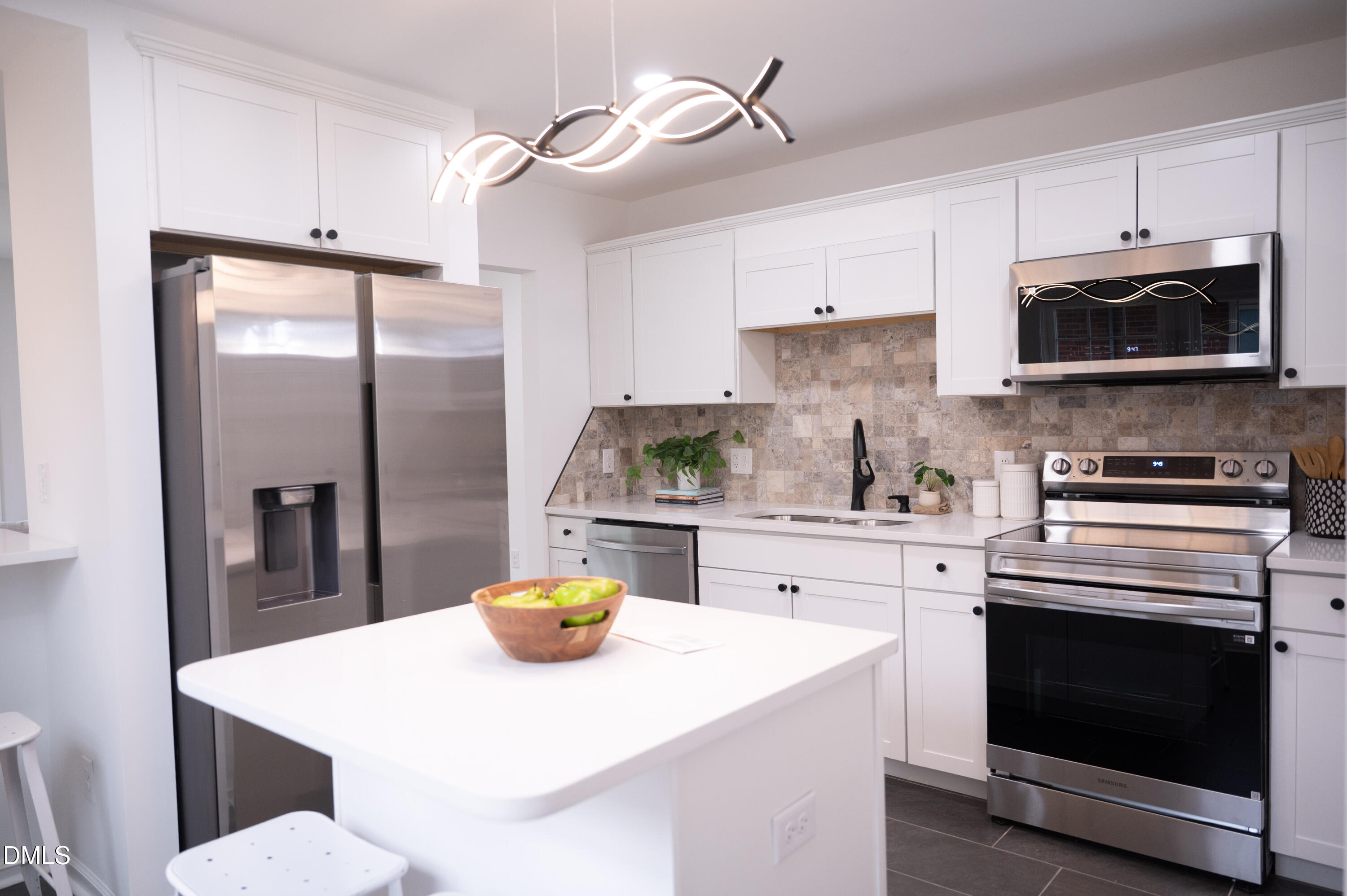 809 Leon Street Durham, NC 27704 - Photo 19 of 30 a kitchen with stainless steel appliances a stove a sink a refrigerator cabinets and dining table