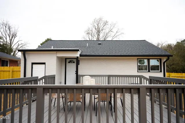 a view of a house with wooden fence