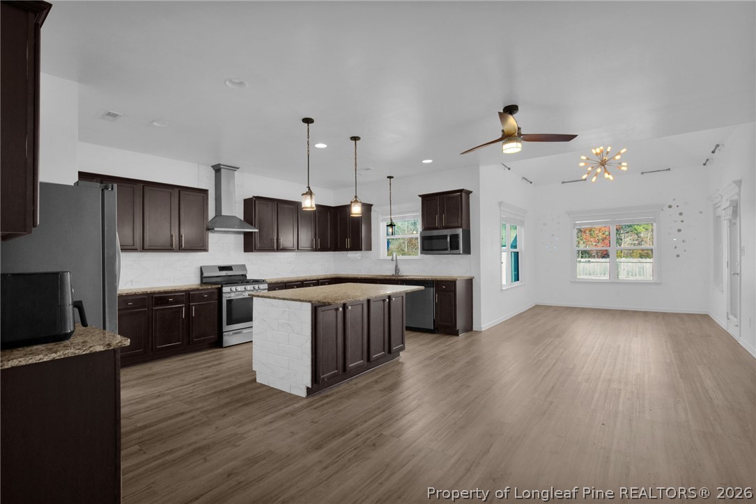 2145 Harrington Road Fayetteville, NC 28306 - Photo 19 of 50 a large kitchen with a wooden floor and stainless steel appliances