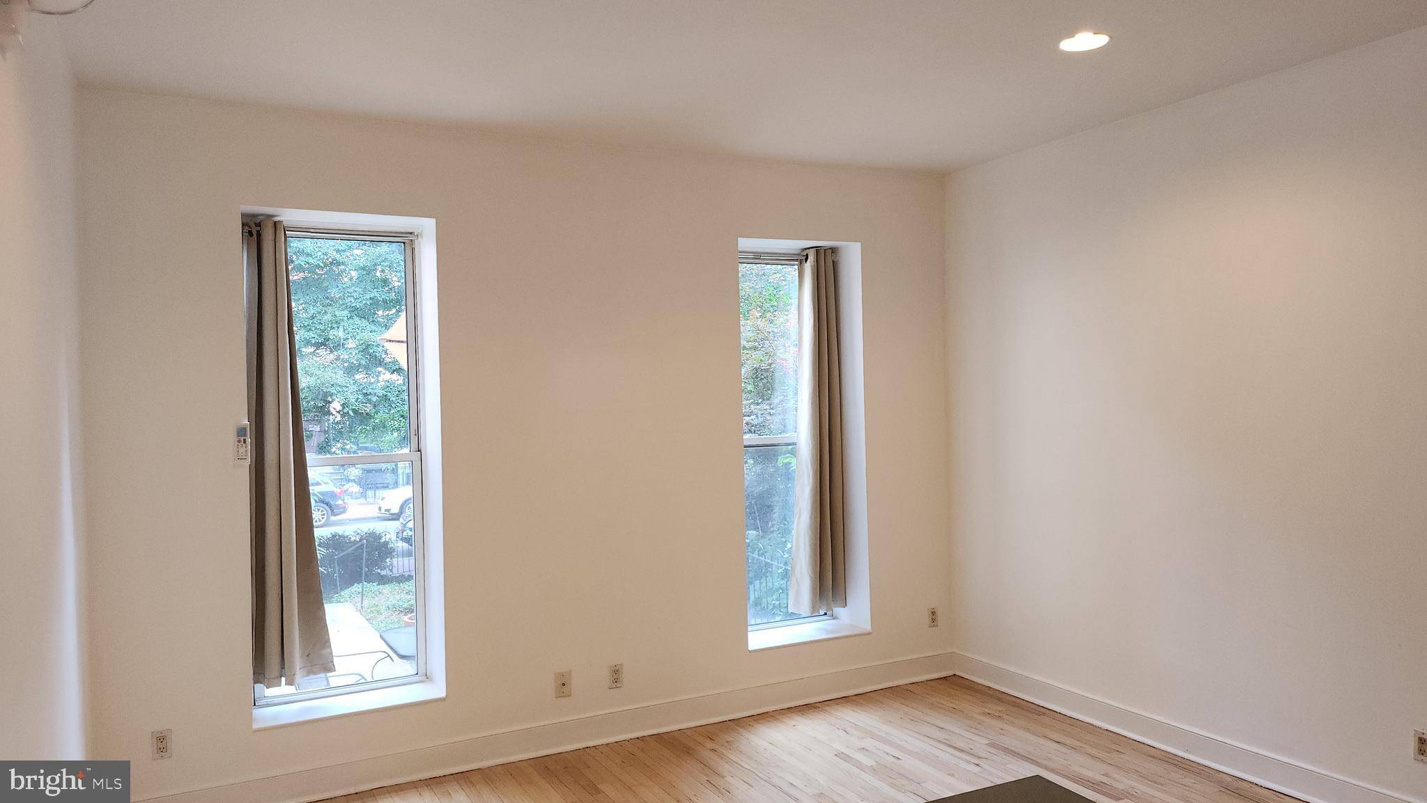 459 M Street Northwest, Unit A Washington, DC 20001 - Photo 10 of 10 an empty room with wooden floor and windows