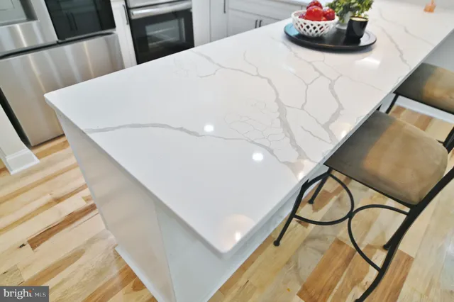 a kitchen with a sink a stove and cabinets