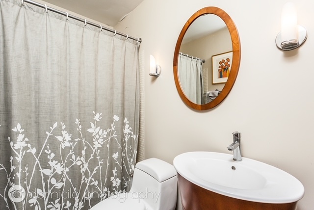 260 East Chestnut Street, Unit 3201 Chicago, IL 60611 - Photo 11 of 15 a bathroom with a sink and a mirror