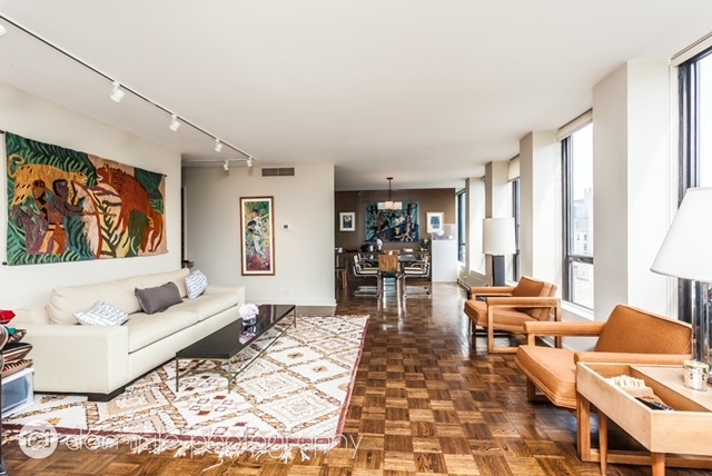 260 East Chestnut Street, Unit 3201 Chicago, IL 60611 - Photo 2 of 15 a living room with furniture and wooden floor