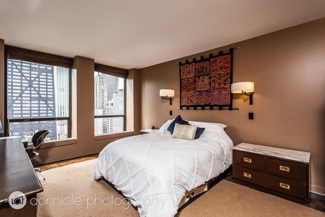 260 East Chestnut Street, Unit 3201 Chicago, IL 60611 - Photo 8 of 15 a bedroom with a bed and a night stand